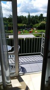 an open door to a balcony with a view of a yard at SILVER ROWY in Rowy