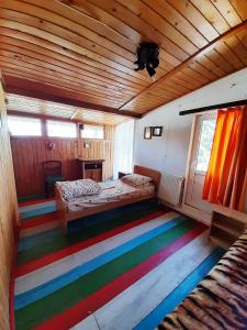a room with a rainbow colored floor in a cabin at Ranch American in Târgovişte