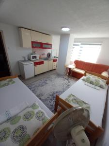 a small room with two beds and a kitchen at Apartment Maida in Dubrave Gornje