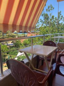 a table and chairs on a balcony with a view at Sulo Villa in Vlorë