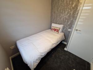 a small bed with a pillow on top of it at Corner House at L3 in Liverpool