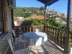 a table and chairs on a balcony with a view at Garden of Edem in Afissos