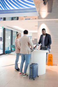 a group of people standing at a counter in an office at Novotel Monte-Carlo in Monte Carlo +37 photos
