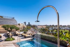 a large swimming pool in a large city at Serras Barcelona in Barcelona