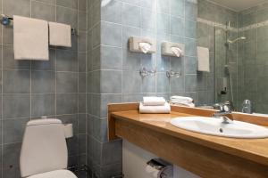 a bathroom with a toilet and a sink at Elite City Hotel, Örebro in Örebro +47 photos