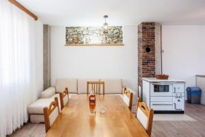 a room with a table and chairs and a couch at Villa Lucia in Vukići