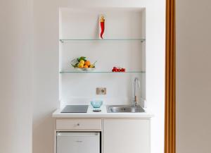 a kitchen with a sink and a bowl of fruit at SORRENTO - Posizione unica nella piazza principale in Sorrento +28 photos