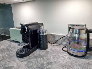 a coffee maker and a blender on a counter at Luxury City Centre Townhouse with Parking in Manchester
