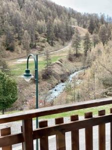 a view of a river from a porch with a street light at Maglines in Vars