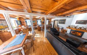 a living room with a table and a fireplace at Pension Rokytka in Kryštofovo Údolí