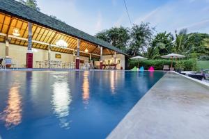 a swimming pool in front of a resort at Kesari Penida by Mahaprana Home in Nusa Penida