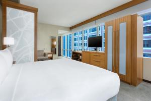 a bedroom with a large white bed and a television at Hyatt Place Chicago/Downtown - The Loop in Chicago +25 photos