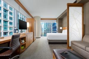 a hotel room with a bed and a desk with a television at Hyatt Place Chicago/Downtown - The Loop in Chicago