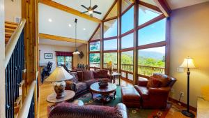 a living room filled with furniture and a large window at --Mountain Chalet Getaway with Breathtaking View Next to Tail of Dragon-- in Robbinsville