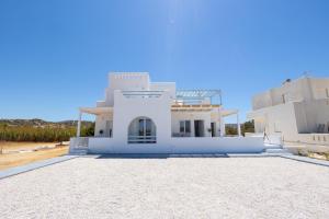 a large white house with a blue sky in the background at Studio 28 in Naxos Chora