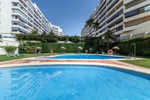 a large swimming pool in front of some buildings at Apartamento Puerto Azul in Marbella