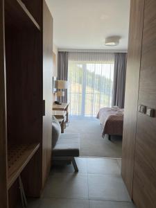 a room with a bedroom with a bed and a desk at Aparthotel Apartamenty Czarna Góra 112 in Sienna