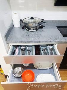 a drawer in a kitchen with a pot on top at Best Sekinchan homestay in Sekinchan