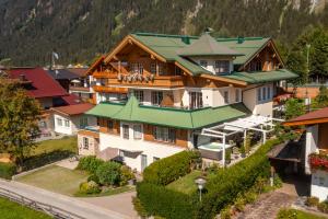 an aerial view of a large house in a village at Apparthotel Sonnenhof in Mayrhofen