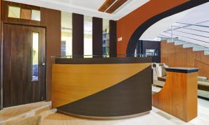 an office lobby with wood paneling and stairs at Itsy By Treebo - Aravind Premiere Kushalnagar in Madikeri