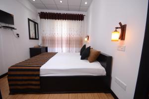 Ένα ή περισσότερα κρεβάτια σε δωμάτιο στο L&D Lodge