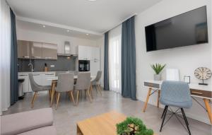 a kitchen and living room with a table and chairs at Awesome Home In Vir With Sauna in Vir