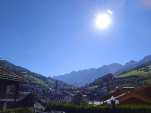 a scenic view of a town with mountains at Hotel les Sapins in La Clusaz