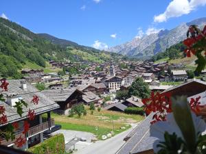 a scenic view of a town with a mountain range at Hotel les Sapins in La Clusaz
