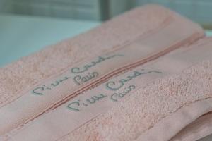 a stack of pink towels with handwriting on them at Sun, Sea, Beach Costa Calida Spain Henrys Apartment in Águilas