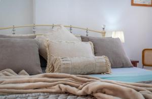 a bed with a blanket and pillows on it at Sun, Sea, Beach Costa Calida Spain Henrys Apartment in Águilas