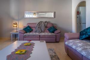 a living room with a couch and a table at Sun, Sea, Beach Costa Calida Spain Henrys Apartment in Águilas