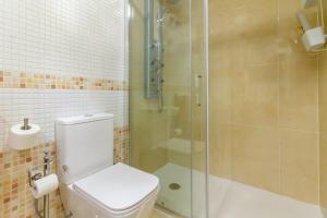a bathroom with a toilet and a glass shower at Sun, Sea, Beach Costa Calida Spain Henrys Apartment in Águilas