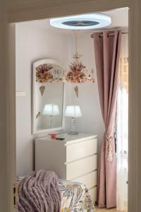 a bedroom with a bed and a mirror and a lamp at Sun, Sea, Beach Costa Calida Spain Henrys Apartment in Águilas