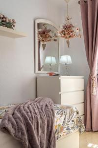 a bedroom with a bed and a mirror at Sun, Sea, Beach Costa Calida Spain Henrys Apartment in Águilas