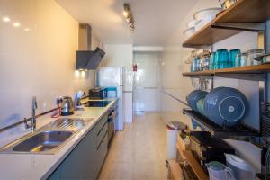 a kitchen with a sink and a counter top at Sun, Sea, Beach Costa Calida Spain Henrys Apartment in Águilas