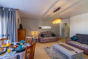 a living room with a table and a couch at Sun, Sea, Beach Costa Calida Spain Henrys Apartment in Águilas