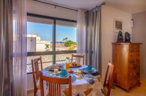 a dining room with a table with a view of the ocean at Sun, Sea, Beach Costa Calida Spain Henrys Apartment in Águilas