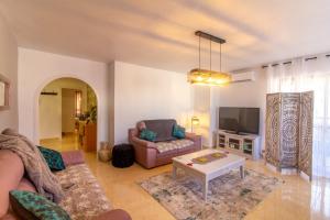 a living room with a couch and a tv at Sun, Sea, Beach Costa Calida Spain Henrys Apartment in Águilas
