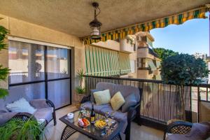 a balcony with a couch and a table on a balcony at Sun, Sea, Beach Costa Calida Spain Henrys Apartment in Águilas
