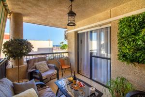 a balcony with a couch and a chair and a table at Sun, Sea, Beach Costa Calida Spain Henrys Apartment in Águilas