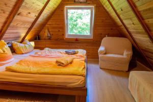 a bedroom with a bed and a chair in a attic at Ferienhaus Gitti in Freest