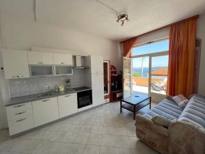 a kitchen and living room with a couch and a table at Eva Apartment 2 in Trogir