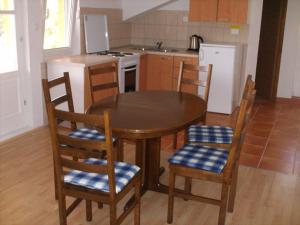 a kitchen with a table and chairs and a kitchen with a stove at Apartment Luna in Molunat +20 photos