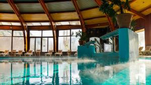 a swimming pool with a water slide in a building at Malalcahuello Thermal Hotel & Spa in Malalcahuello