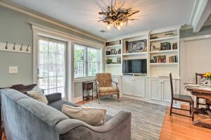 a living room with a couch and a tv at Elegant Savannah Hideaway with Private Garden in Savannah