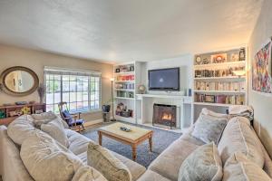 a living room with a couch and a fireplace at Whimsical Sacramento Home with Garden and Patio! in Sacramento