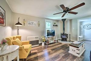 a living room with a couch and a ceiling fan at Charming Waynesville Cottage Less Than 2 Mi to Main St in Waynesville