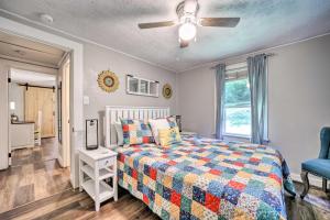 a bedroom with a bed and a ceiling fan at Charming Waynesville Cottage Less Than 2 Mi to Main St in Waynesville