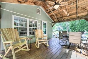 a porch with rocking chairs and a ceiling at Charming Waynesville Cottage Less Than 2 Mi to Main St in Waynesville