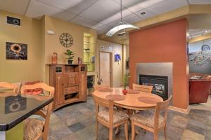a kitchen and dining room with a table and chairs at Idyllic Dtwn Anchorage Condo with Fireplace! in Anchorage
